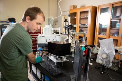 A student works with physics equipment.