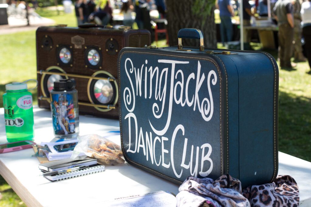 A navy blue trunk with Swing Jacks Dance Club written on it at the club fair