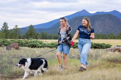 Two students and their dog walk the Buffalo Park loop.