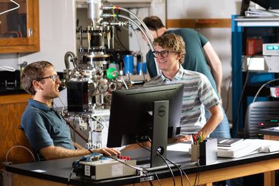 A student speaks with professor, Mark Loeffler in the lab.